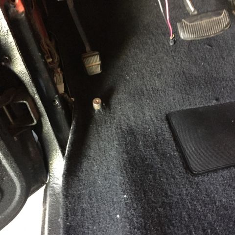 Black carpet floor near pedals and door sill of a Ford truck