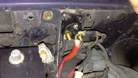 1994 Ford Bronco - Photograph of a starter solenoid mounted on the inner fender with battery and starter cables attached.