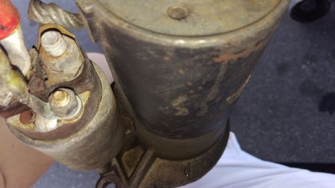 1994 Ford Bronco - Close-up photograph of a corroded starter and solenoid showing terminal studs and cable connections.
