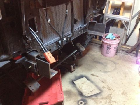 Truck front frame and radiator support with fabricated brackets in a garage