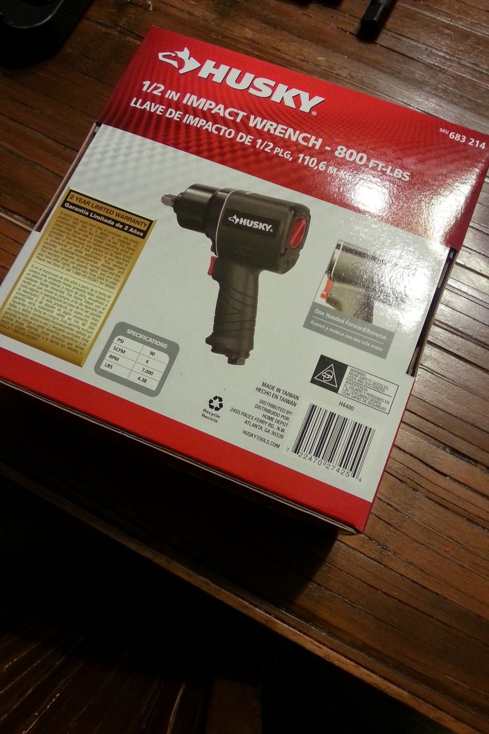 Back of a Husky 1/2 inch impact wrench retail box on a wood table