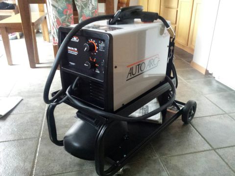 Auto Arc MIG welder on a wheeled cart in a tiled room