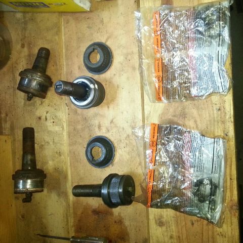 Ball joints, sockets, and replacement parts in bags laid out on plywood
