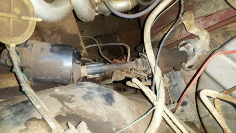 Close-up of vehicle steering shaft, U-joints, and rubber boot.