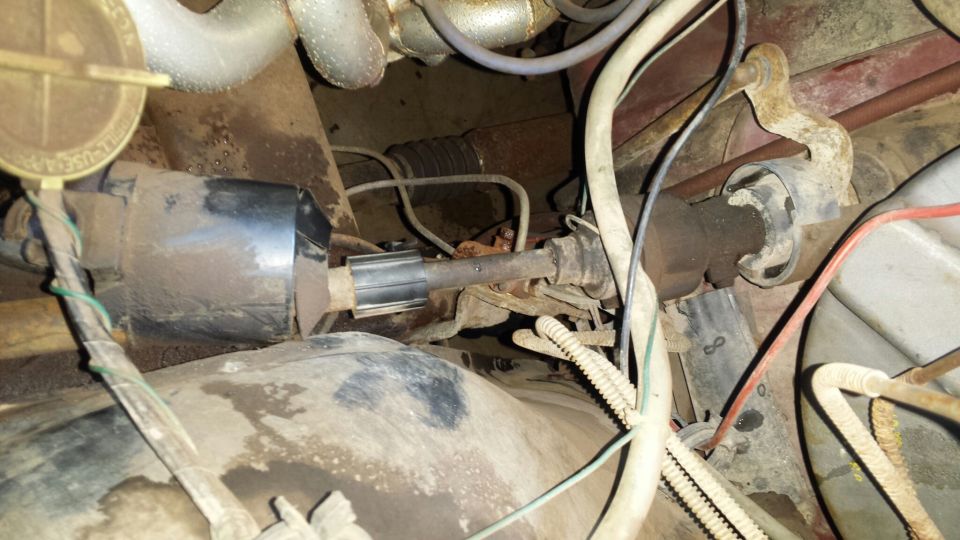 Close-up of vehicle steering shaft, U-joints, and rubber boot.