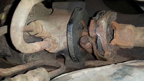 Rusted universal joint and driveshaft part on a vehicle