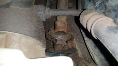 Rusty universal joint and steering column assembly.