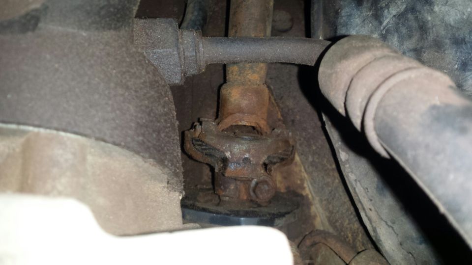 Rusty universal joint and steering column assembly.