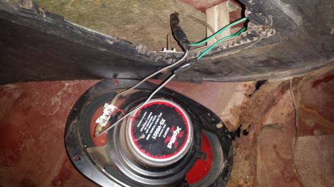 Sony Xplod speaker with wiring, in a vehicle with rust.