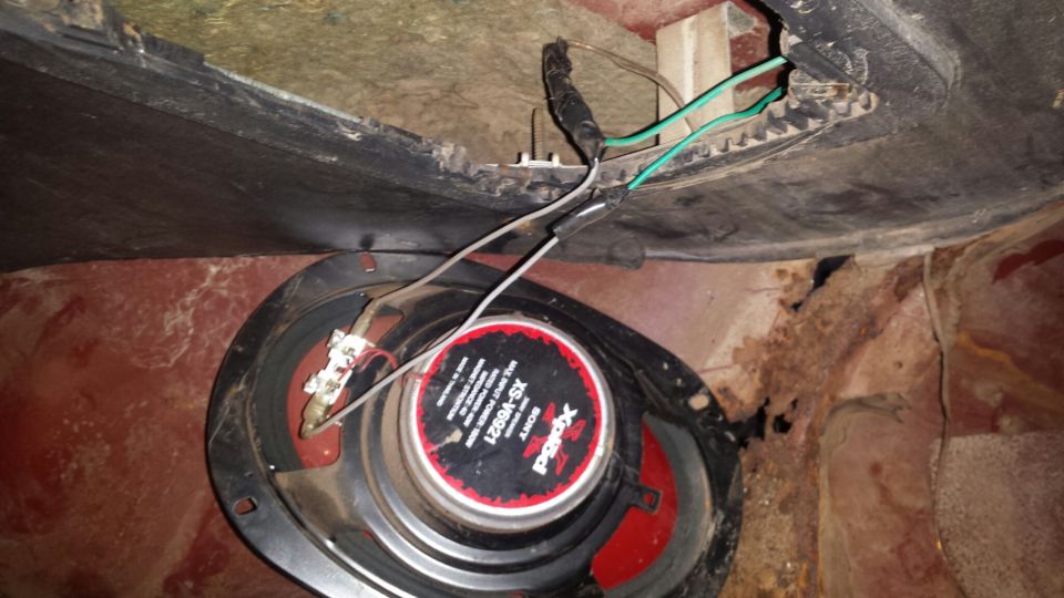 Sony Xplod speaker with wiring, in a vehicle with rust.