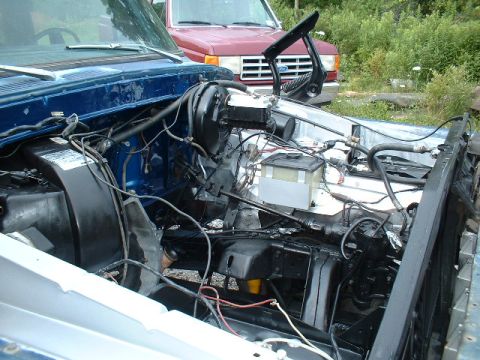 1978 Ford F-250 - The engine bay of a blue 1978 Ford F-250 shows the brake booster and master cylinder assembly.