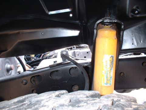 1978 Ford F-250 - Close-up view of truck undercarriage, showing suspension and tire.
