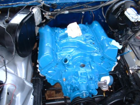 1978 Ford F-250 - A freshly painted blue engine block is visible in the engine bay, with some wiring and components around it.