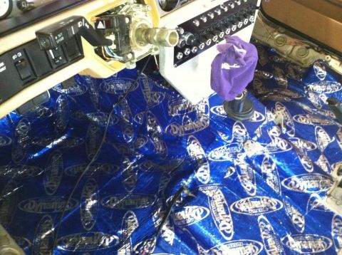 1991 Volvo 940 - Sound deadening material is being installed on the floor of a vehicle's interior.