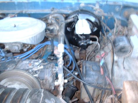 1978 Ford F-250 - Close-up view of the engine bay, showing the brake booster, air cleaner, and various hoses and wires.