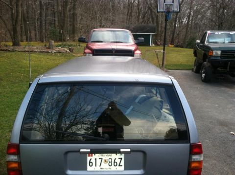 1991 Volvo 940 - A silver 1991 Volvo 940 station wagon is parked in a driveway with other vehicles visible.