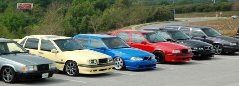 1991 Volvo 940 - A row of Volvo 940 sedans and wagons are parked side-by-side.