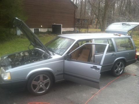 1991 Volvo 940 - Silver 1991 Volvo 940 station wagon with hood and doors open, parked outside.