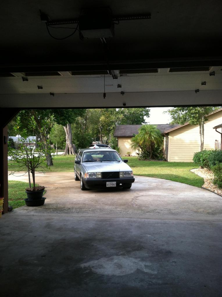 Silver 1991 Volvo 940 sedan parked in driveway, viewed from garage