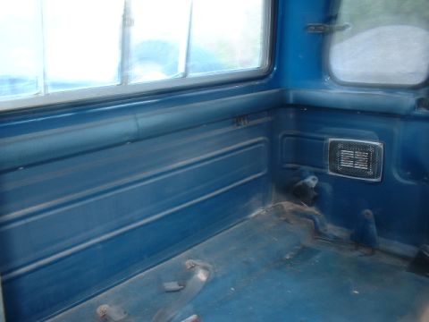 1978 Ford F-250 - The interior of a blue pickup truck bed shows ribbed paneling and a speaker grille, with a watermark at the bottom.