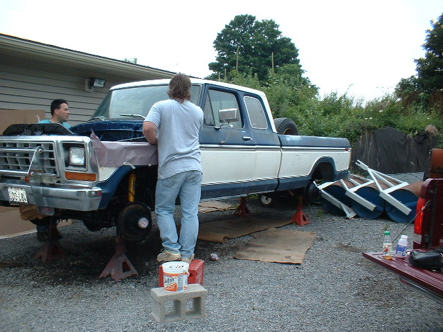 1978 Ford F-250 truck on jack stands, blue and white, front end disassembled