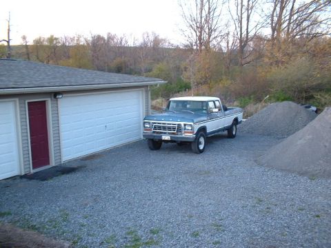 1978 Ford F-250 - 1978 Ford F-250 pickup truck parked in a gravel driveway beside a garage.