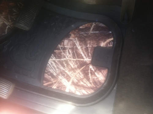 Camouflage floor mat with pedals in a vehicle