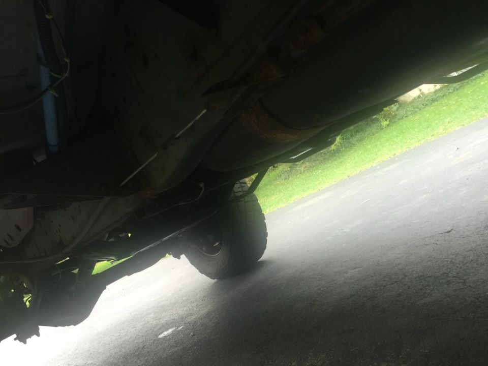 Underside of a Dodge 2500 pickup truck, showing fuel tank, exhaust, and rear axle.