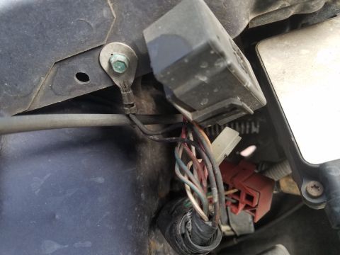 1994 Ford Bronco - Photograph of a wiring harness and electrical connectors in the engine bay near a module.