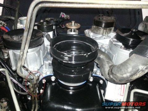1994 Ford Bronco - Photograph of engine accessory pulleys and drive components with a fastener circled in red.