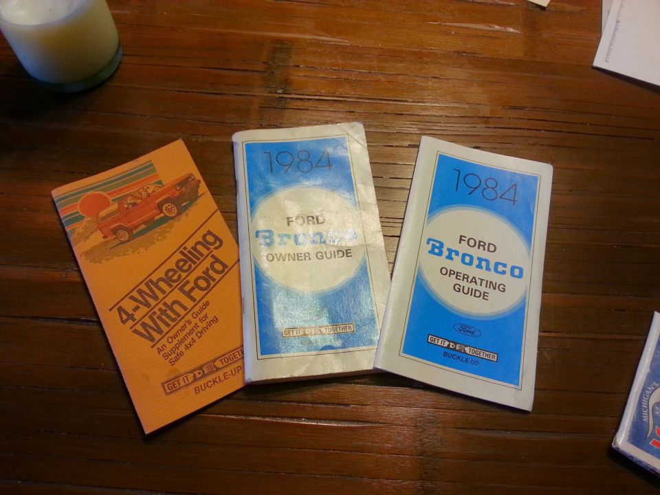 Three Ford booklets: 4-Wheeling With Ford, 1984 Bronco Owner Guide, 1984 Bronco Operating Guide