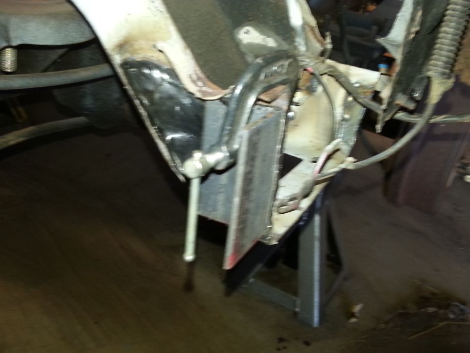 Close-up of metal fabrication and welding on vehicle undercarriage.