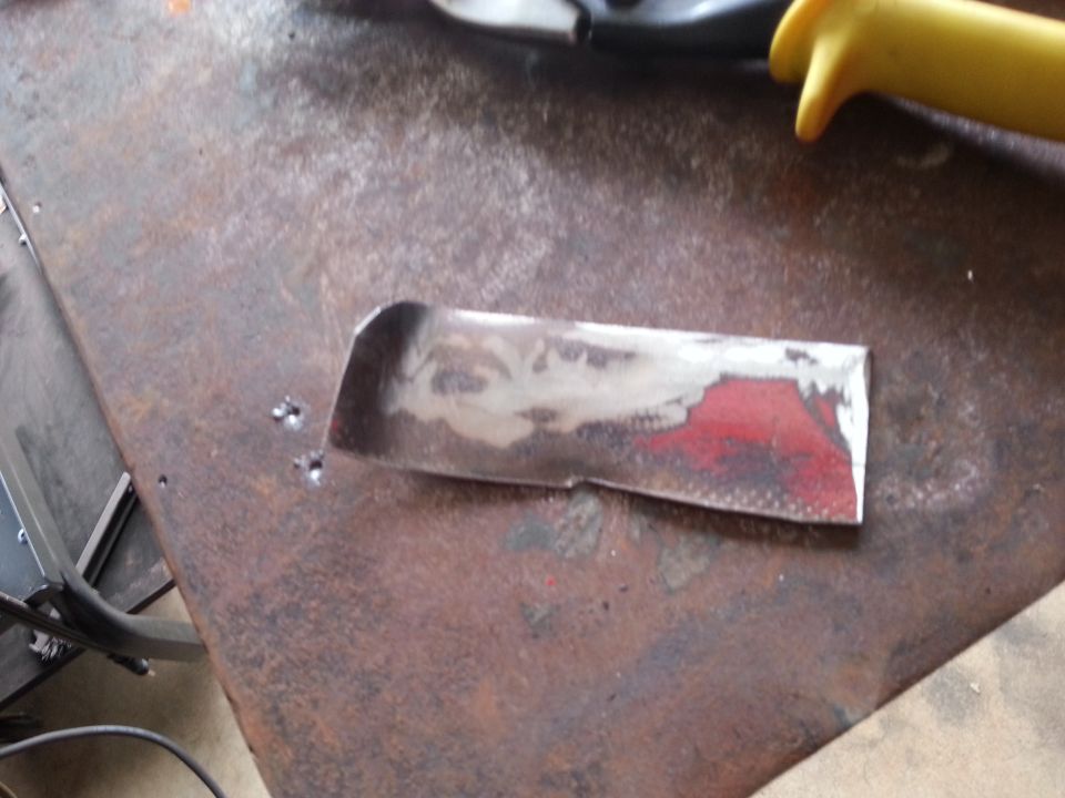 Metal part with red paint on a rusty surface