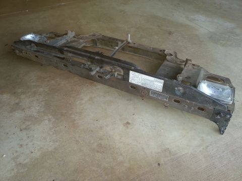 Black metal vehicle frame assembly with headlight
