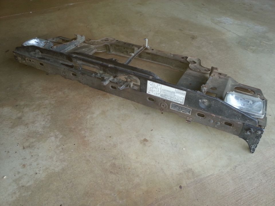 Black metal vehicle frame assembly with headlight