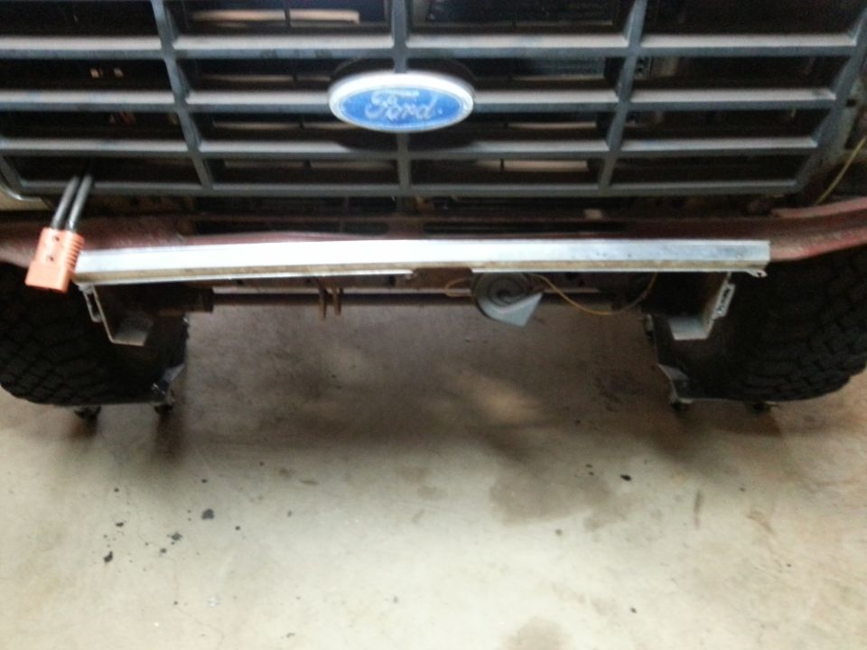 Ford Bronco front grille and bumper with a silver bar and horn.