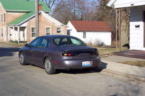 1996 Ford Taurus - Rear view of a 1996 Ford Taurus sedan parked curbside on a residential street.