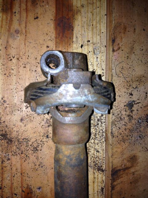 Driveshaft universal joint on a wooden background