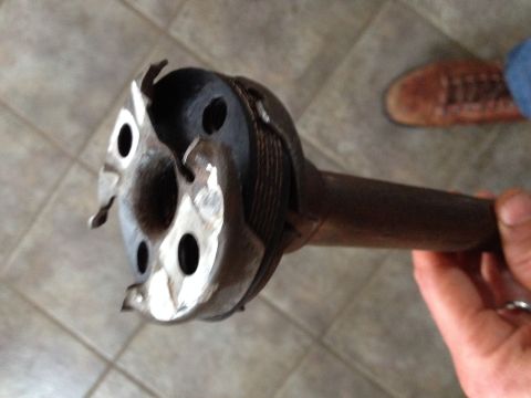 Close-up of a driveshaft U-joint with visible wear and damage