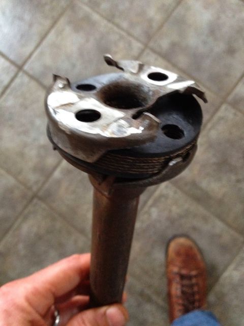 Hand holding a worn distributor cap and rotor assembly