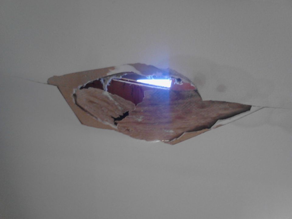 Hole in ceiling with insulation showing