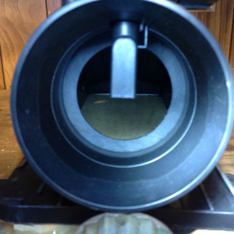 1996 Ford Bronco - This is a close-up, interior view of a mass airflow sensor housing. The metallic sensor element is visible inside the dark, circular housin…