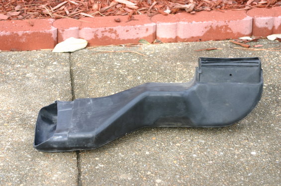 Black plastic air intake duct on concrete