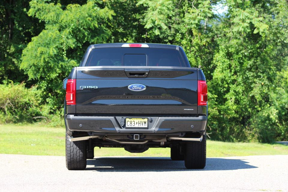 Rear view of a black 2015 Ford F-150 pickup truck with a NJ license plate.
