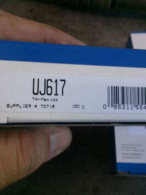 1996 Ford Bronco - A close-up shot of a white label with blue trim on a box. The label has text including "UJ617", "74-Mexico", "SUPPLIER # 70719", "150 0", a…