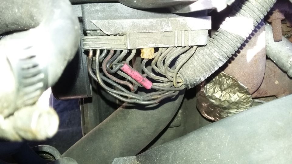 Close-up of electrical wires and connector with a pink crimp connector.
