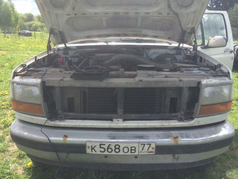 1993 Ford Bronco - Front view of a 1992 Ford F-Series truck with the hood open, revealing the engine.