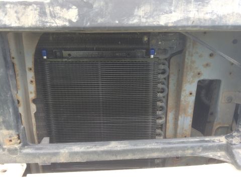 1993 Ford Bronco - Close-up view of the radiator and condenser assembly, showing the fins and blue fittings.