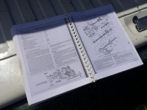 1993 Ford Bronco - Open repair-manual spread showing specification text and exploded driveline component figures.