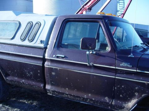 1992 Ford Bronco - This Ford F-250 pickup truck features a white camper shell and a "F250 CUSTOM" badge on the fender.